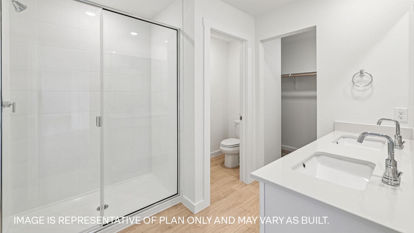 Luxurious primary bathroom with double vanity sink and walk-in shower.