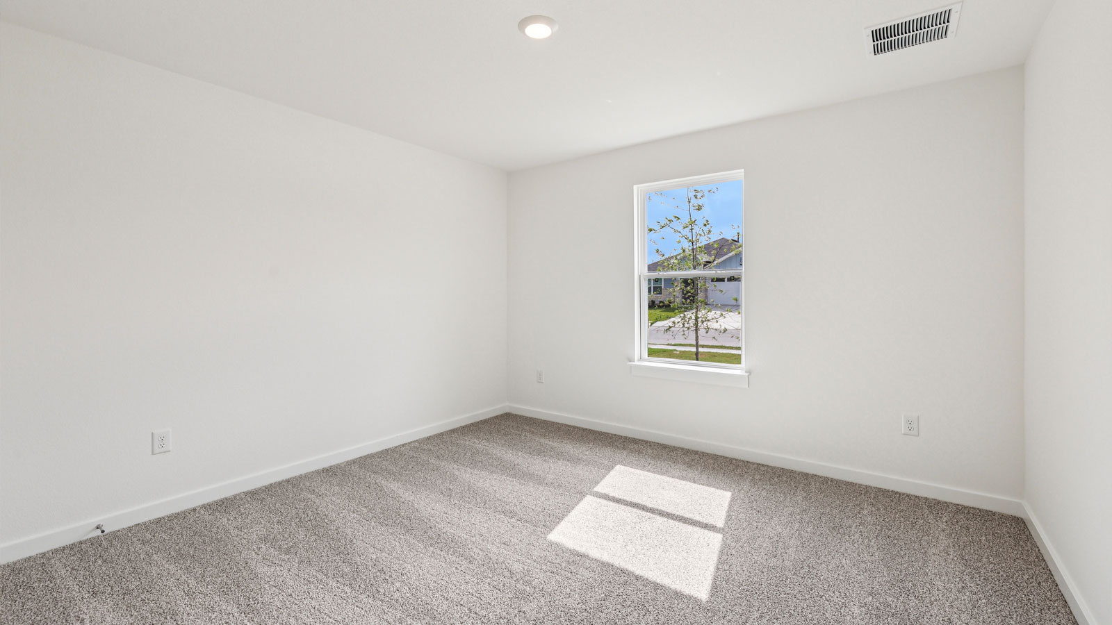 Secondary bedroom with carpeted flooring.