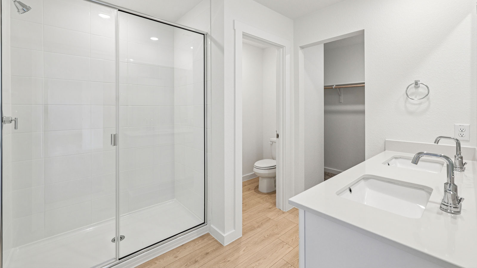 Luxurious primary bathroom with double vanity sink and walk-in shower.