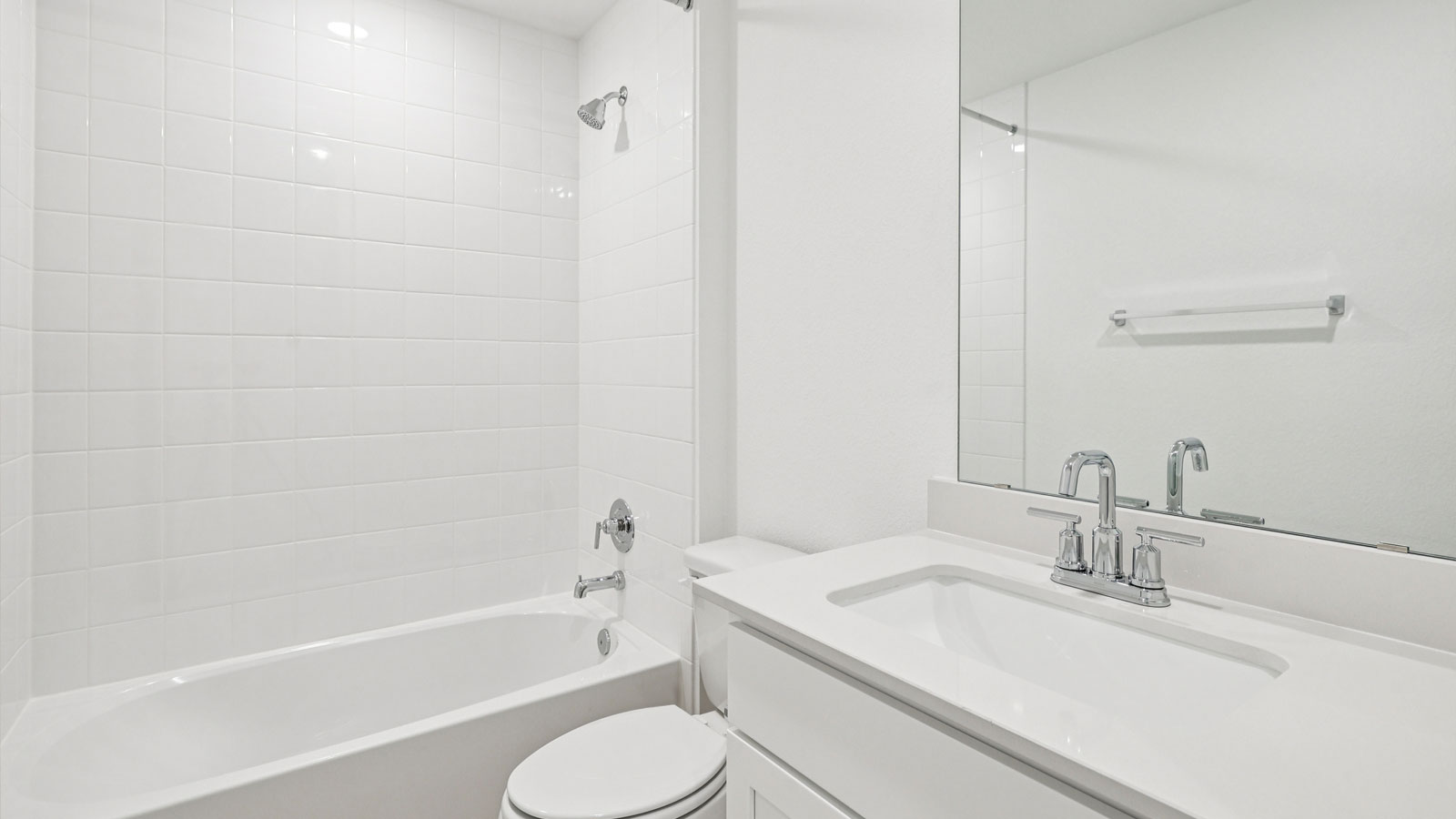 Secondary bathroom with tub and raised shower head.