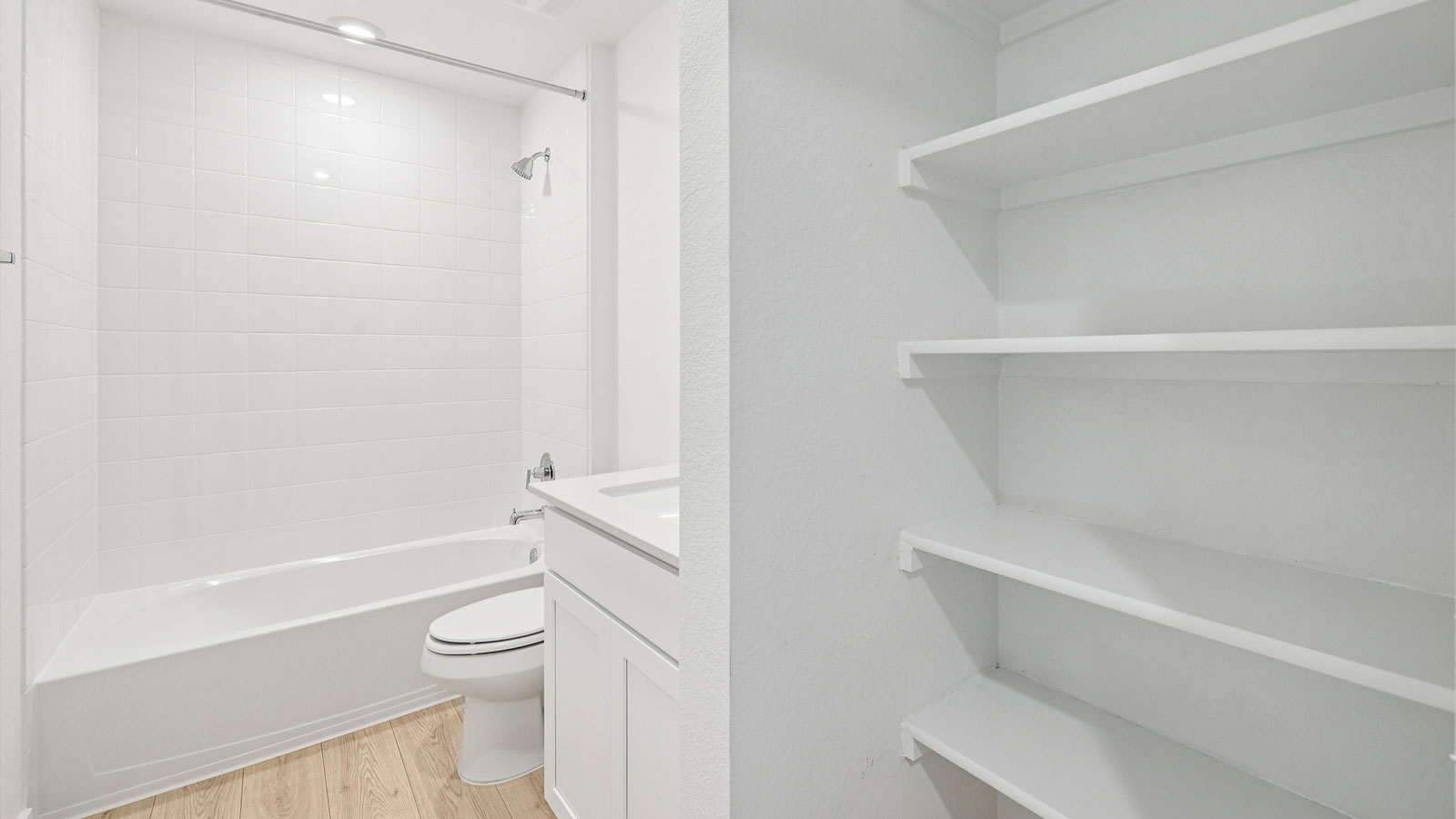 Secondary bathroom with tub and raised shower head.