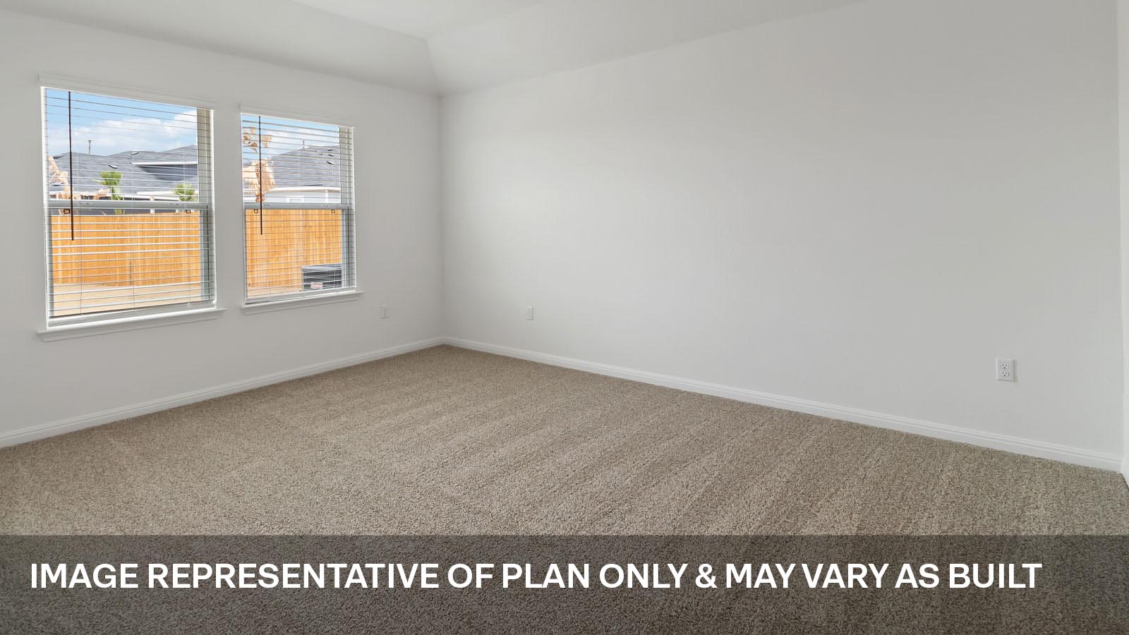 Spacious main bedroom with carpeted flooring.