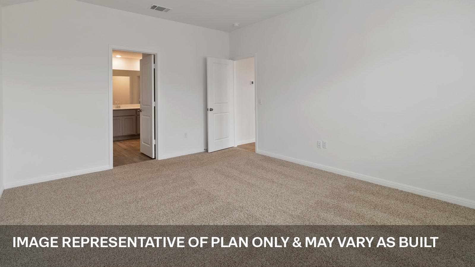 Spacious main bedroom with carpeted flooring.