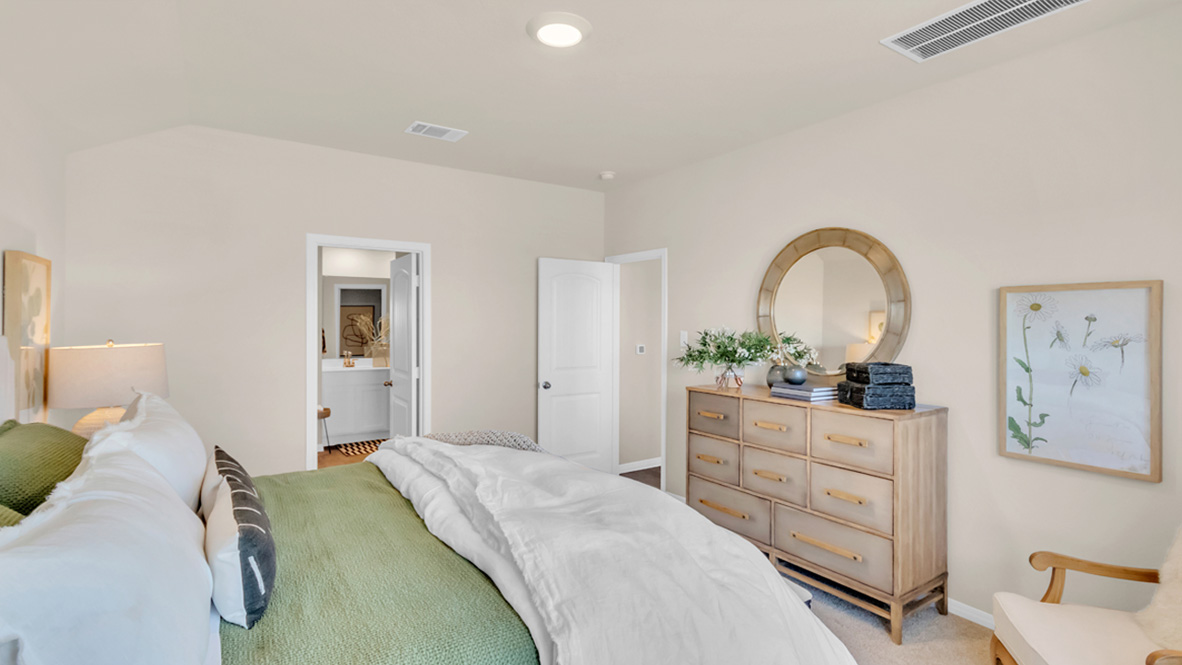 Main bedroom with carpeted floors and window.