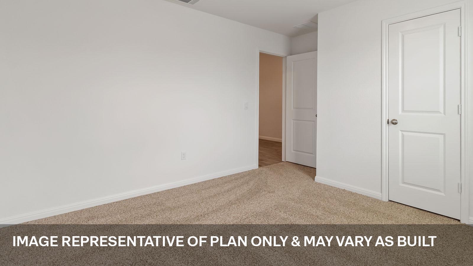 Secondary bedroom with carpeted flooring.