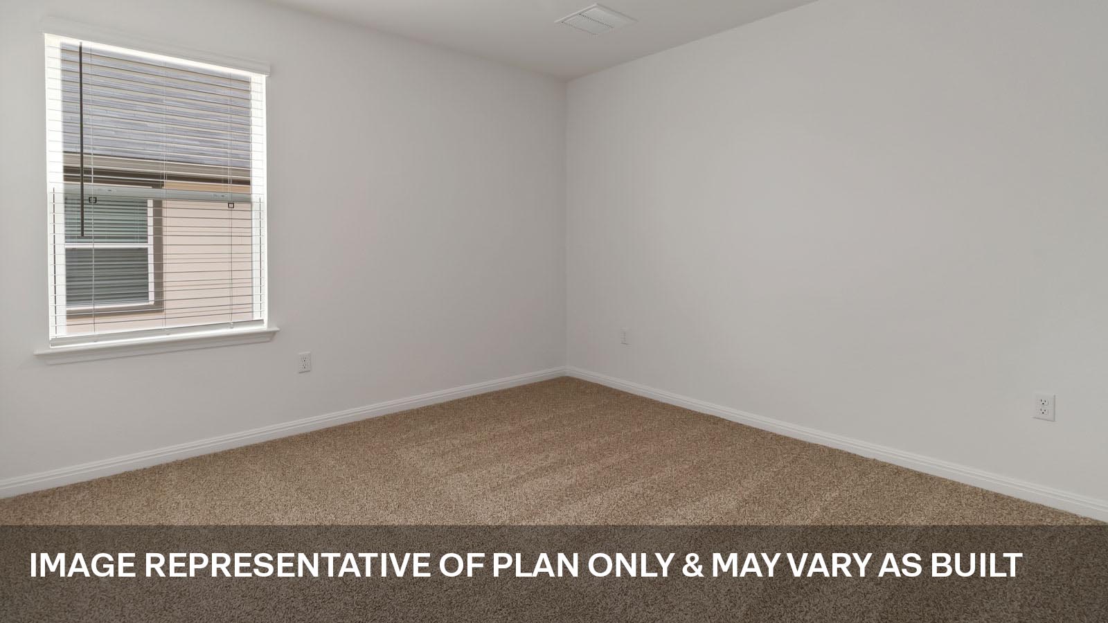 Secondary bedroom with carpeted flooring.