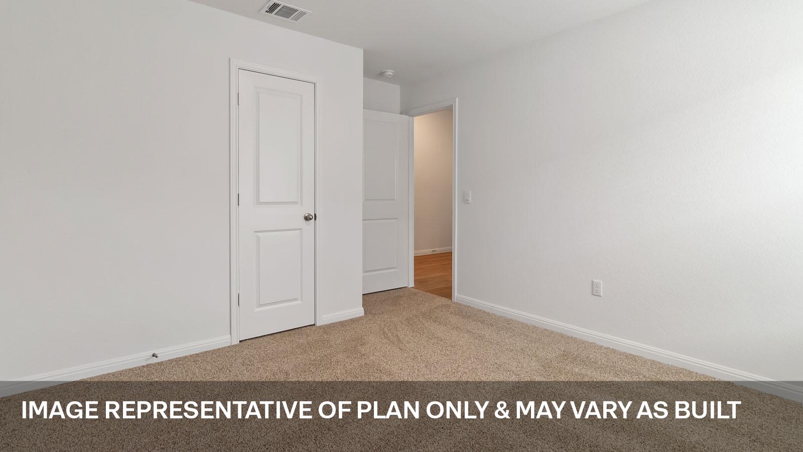 Secondary bedroom with carpeted flooring.