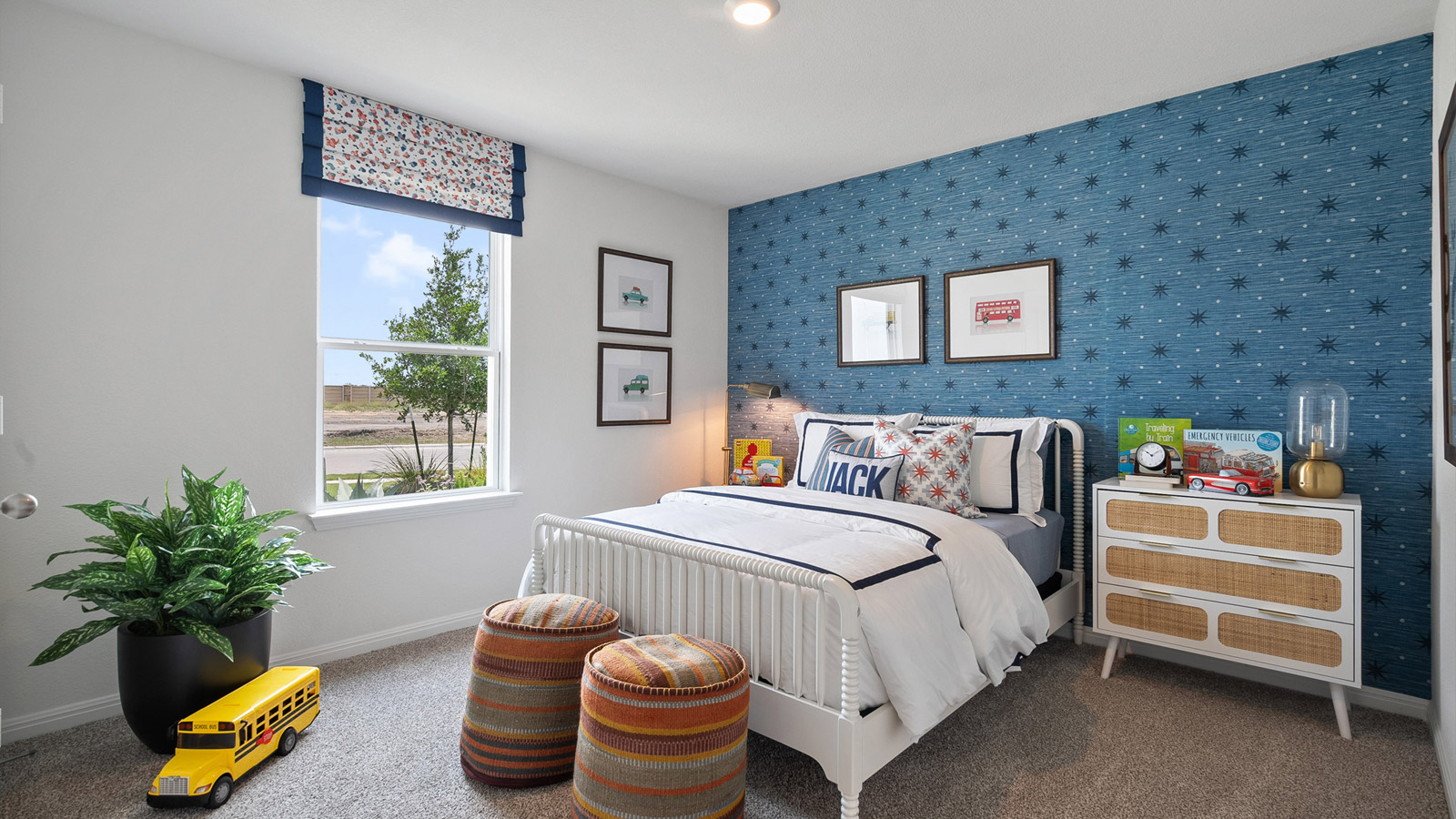 Bedroom 2 located at the front of the home with carpeted floors and window.