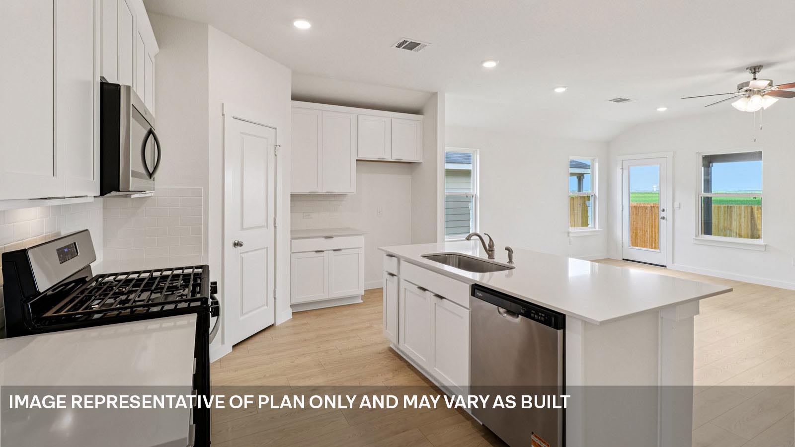 Stainless steel dishwasher, gas range, and microwave in  kitchen.