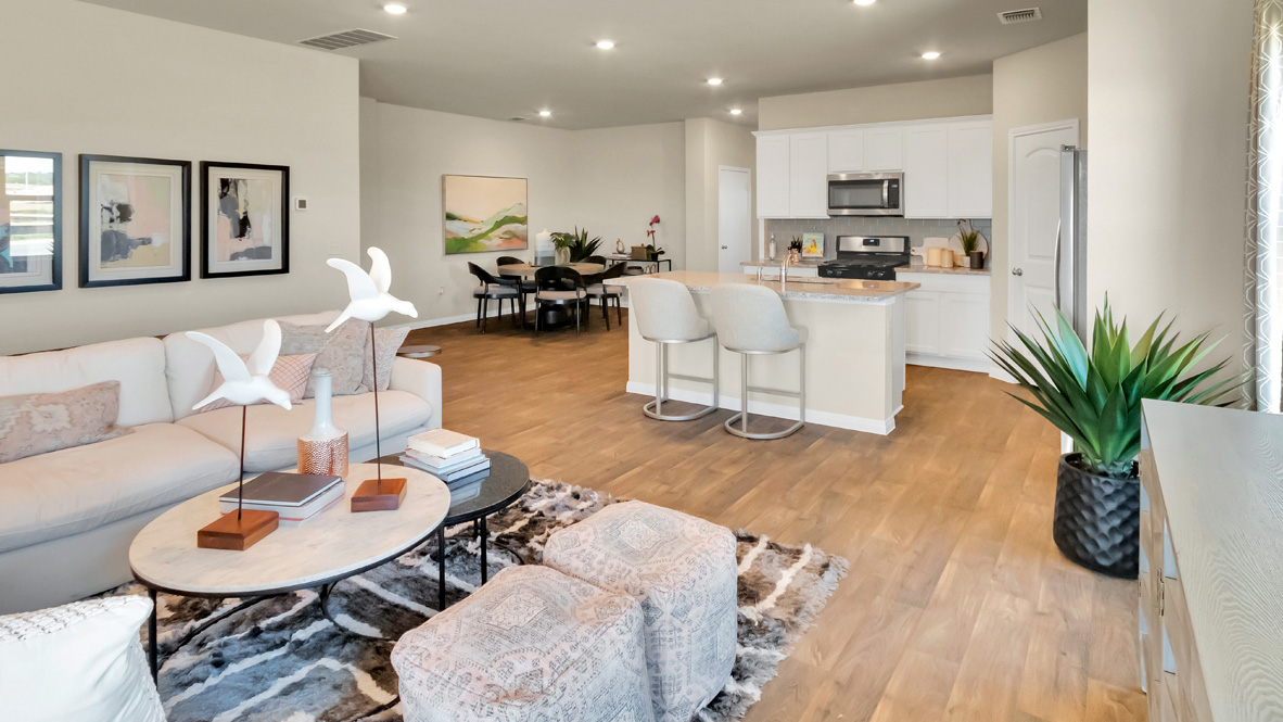 spacious kitchen featuring white cabinetry, large island and stainless steel appliances