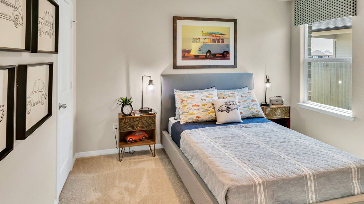bedroom with a blue bed, with a window and night stands on either side