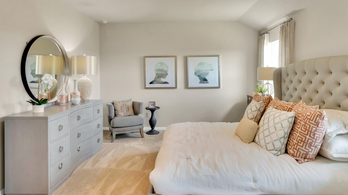 bedroom with an upholstered king bed, with night stands and windows on either side