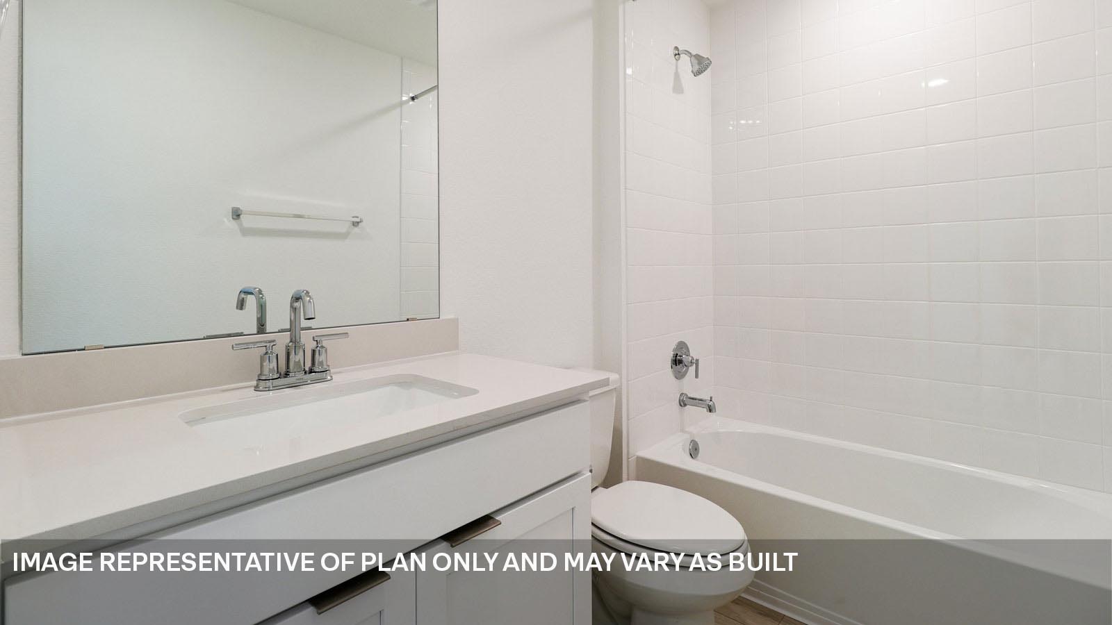 Secondary bathroom with tub and raised shower head.