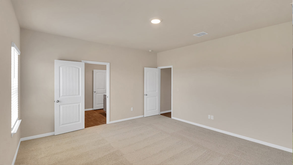 Main bedroom with carpeted floors.