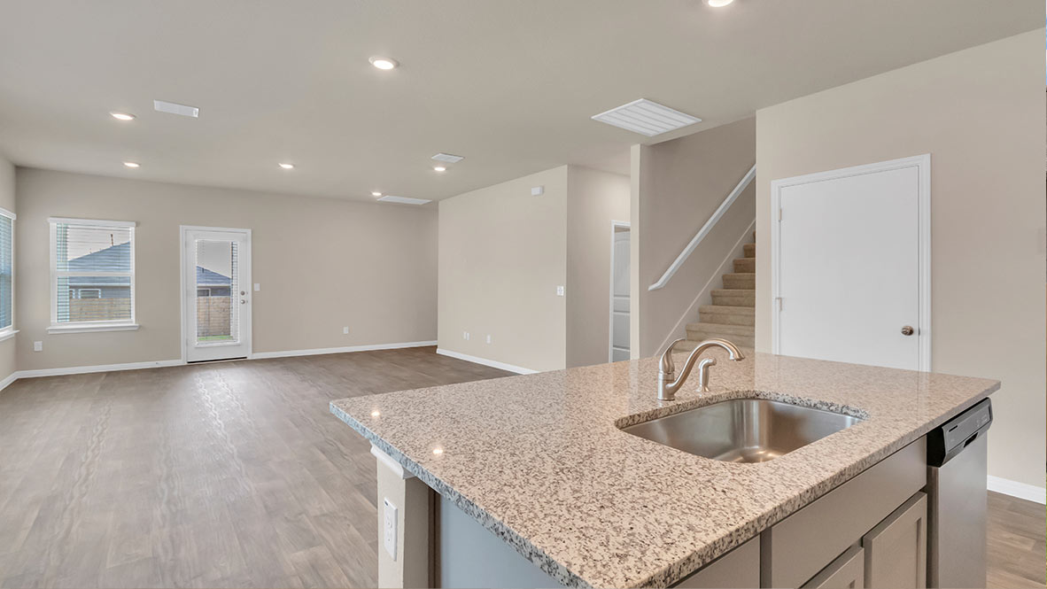 Open concept kitchen and living area with view of kitchen island.