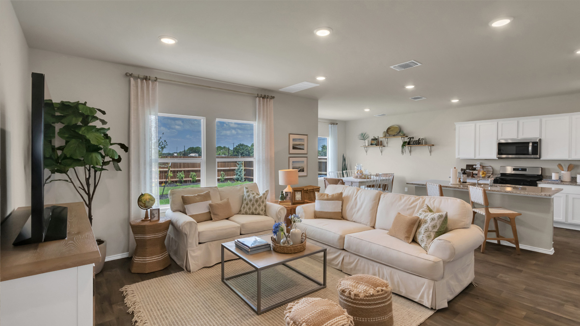 spacious living room with white sofas, and neutral decor