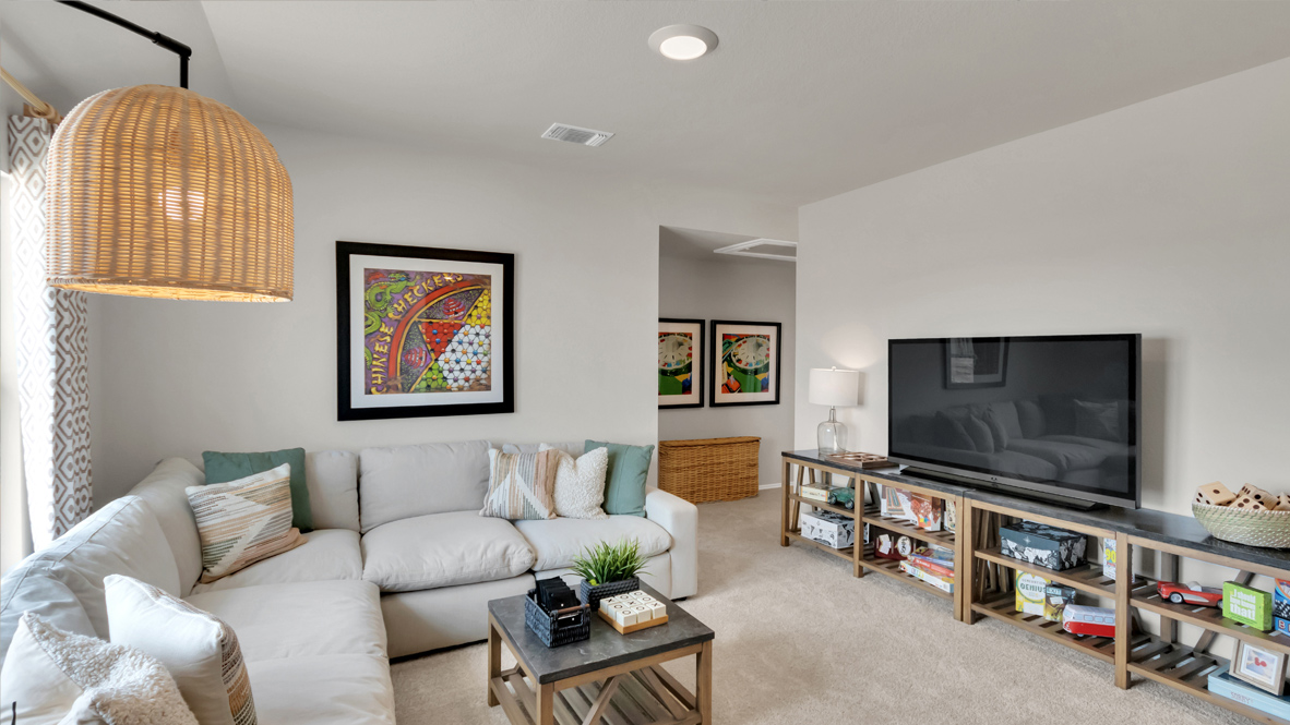 upstairs flex room with a sectional and TV