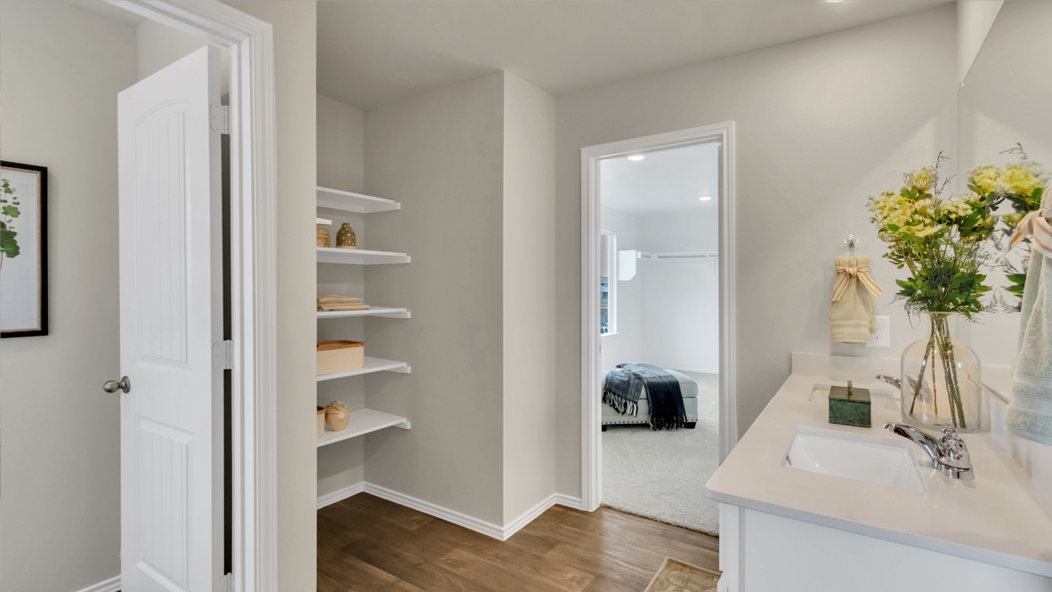 primary bathroom with a walk in shower and vanity sink