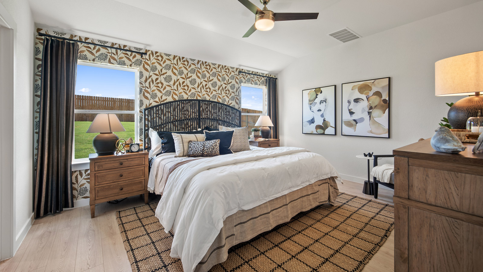 Luxurious main bedroom with laminated wood flooring and ensuite bathroom.