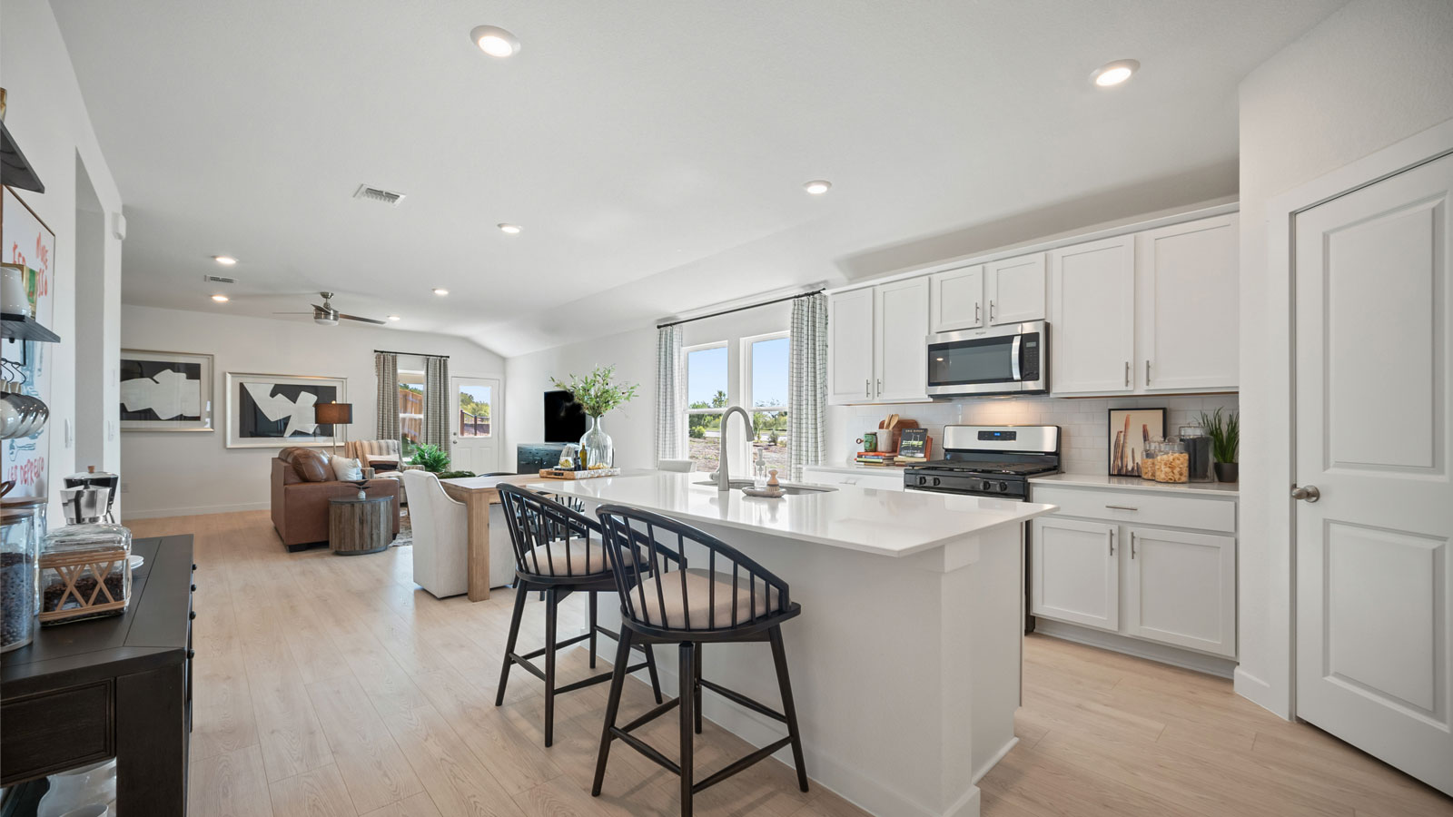 Gourmet kitchen with quartz countertops and decorative backsplash.