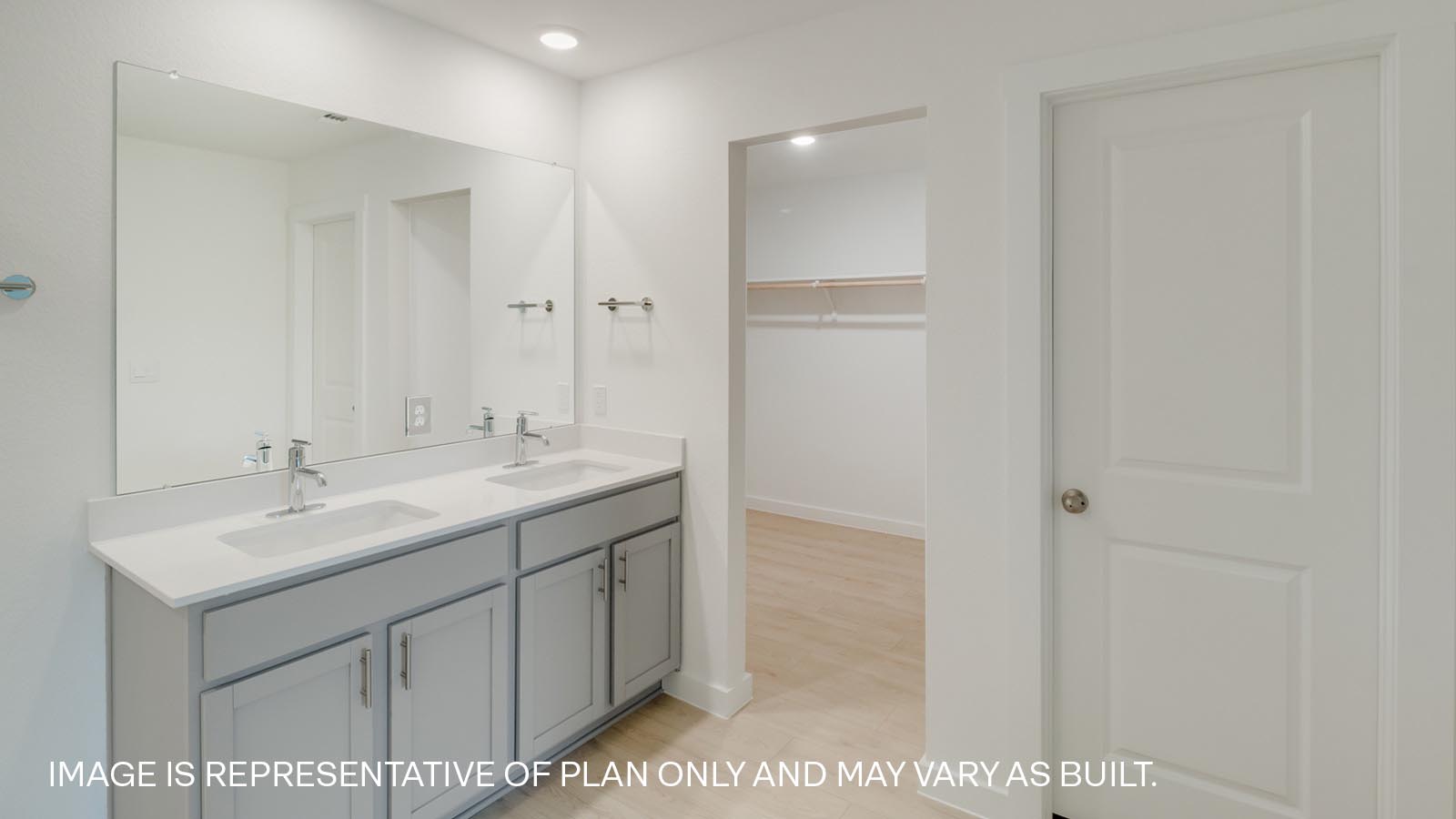 Primary bathroom with quartz vanity.