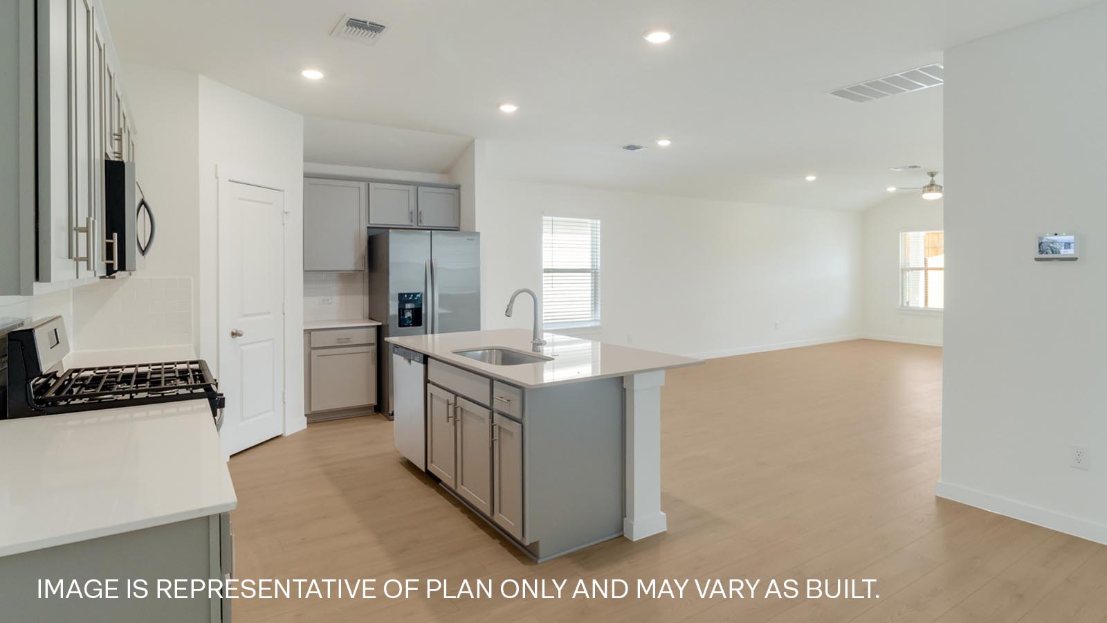 Open kitchen with quartz countertops.