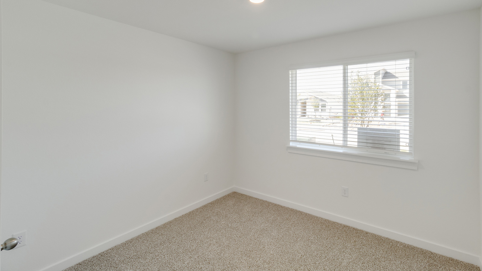 Bedroom 2 with carpeted flooring.