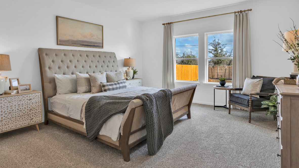 bedroom with an upholstered bed, with a large window