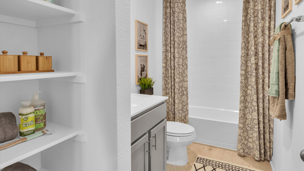 bathroom with a vanity sink, toilet, and shower