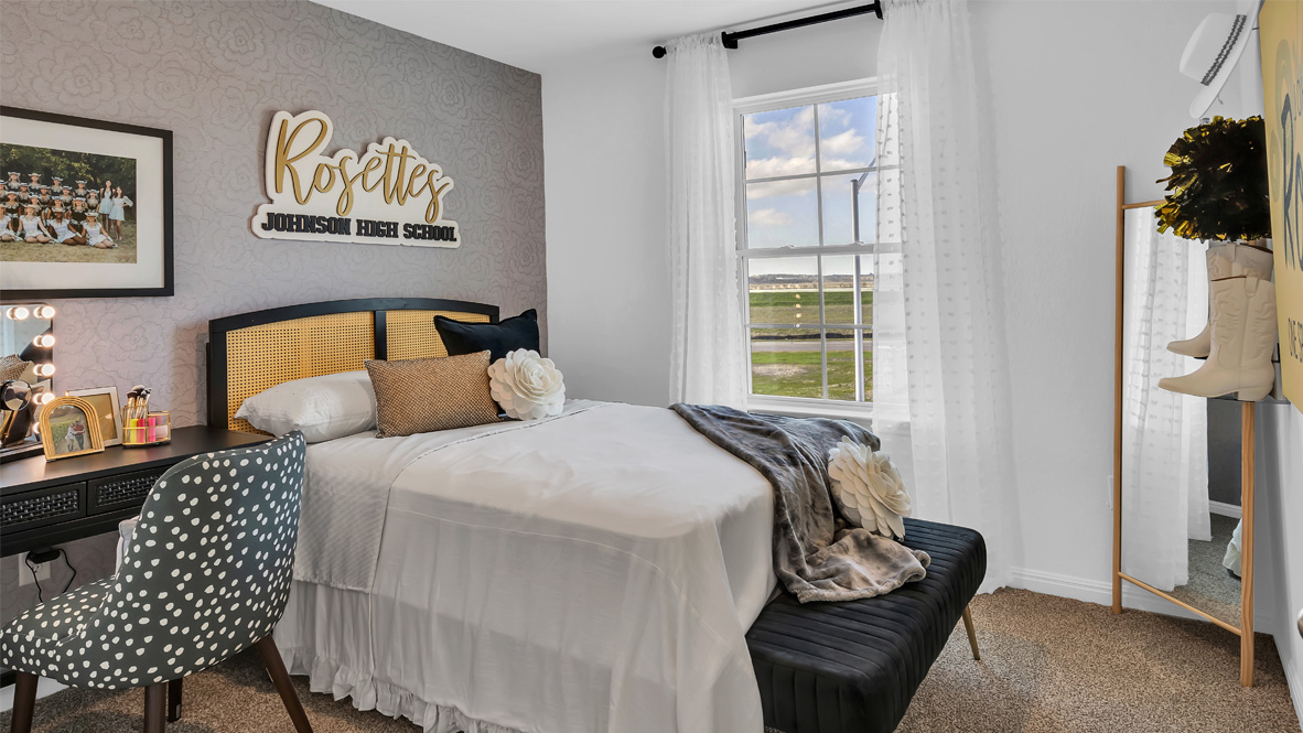 bedroom with a grey bed and a window