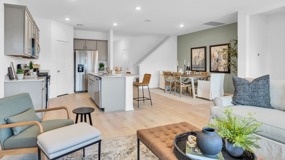 spacious living room featuring a sectional, with green and gray decor