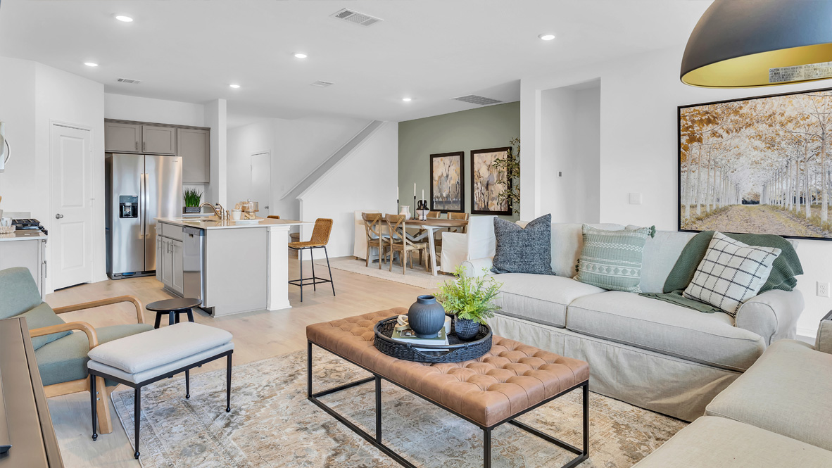 spacious living room featuring a sectional, with green and gray decor