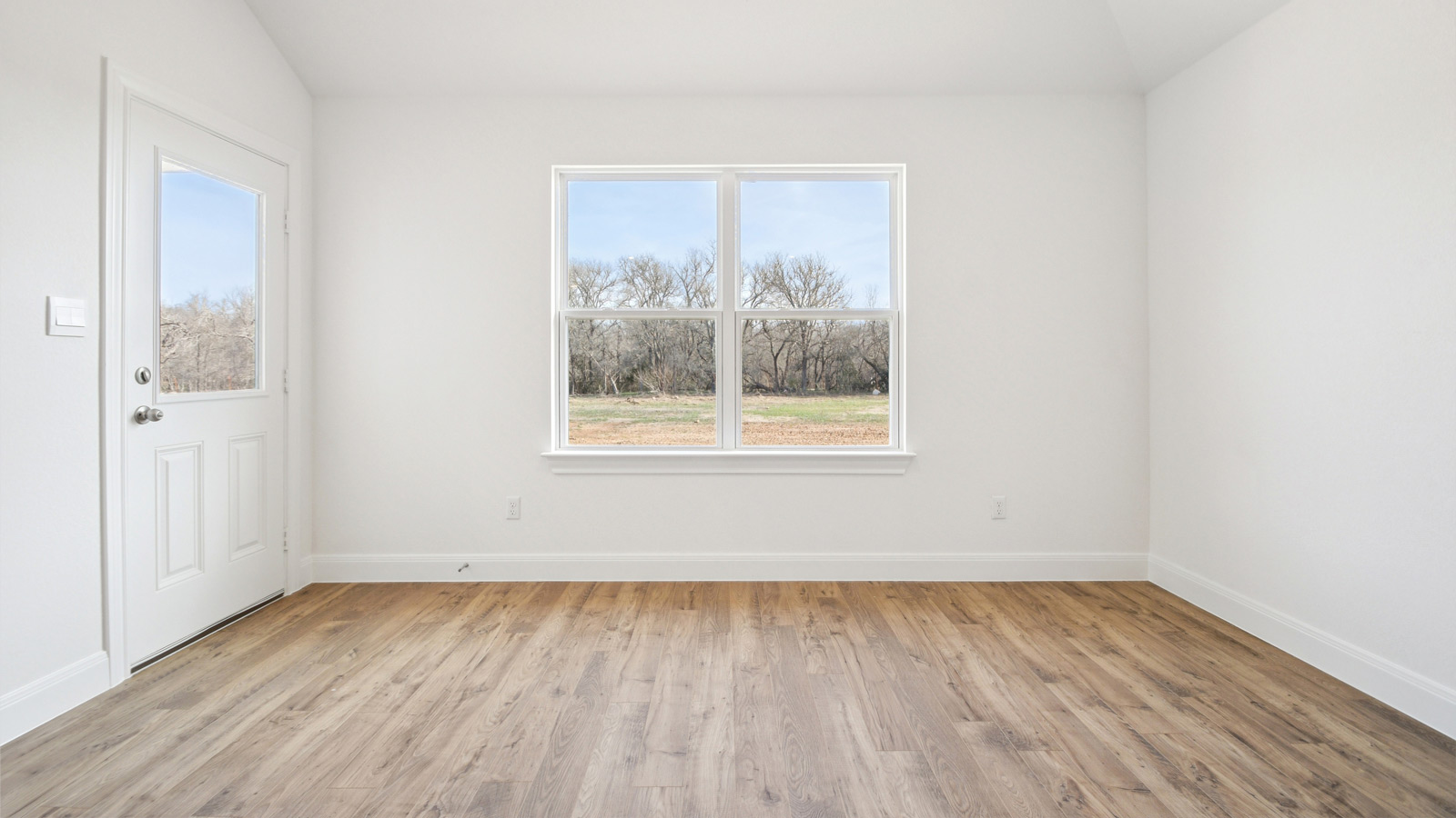 Dining area with two windows and backdoor.