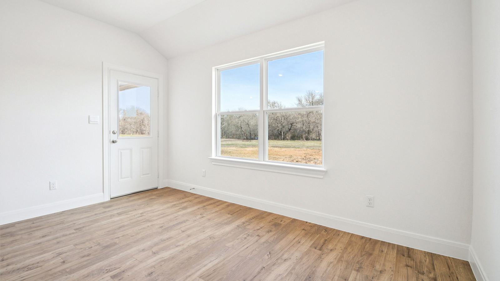 Dining area with two windows and backdoor.