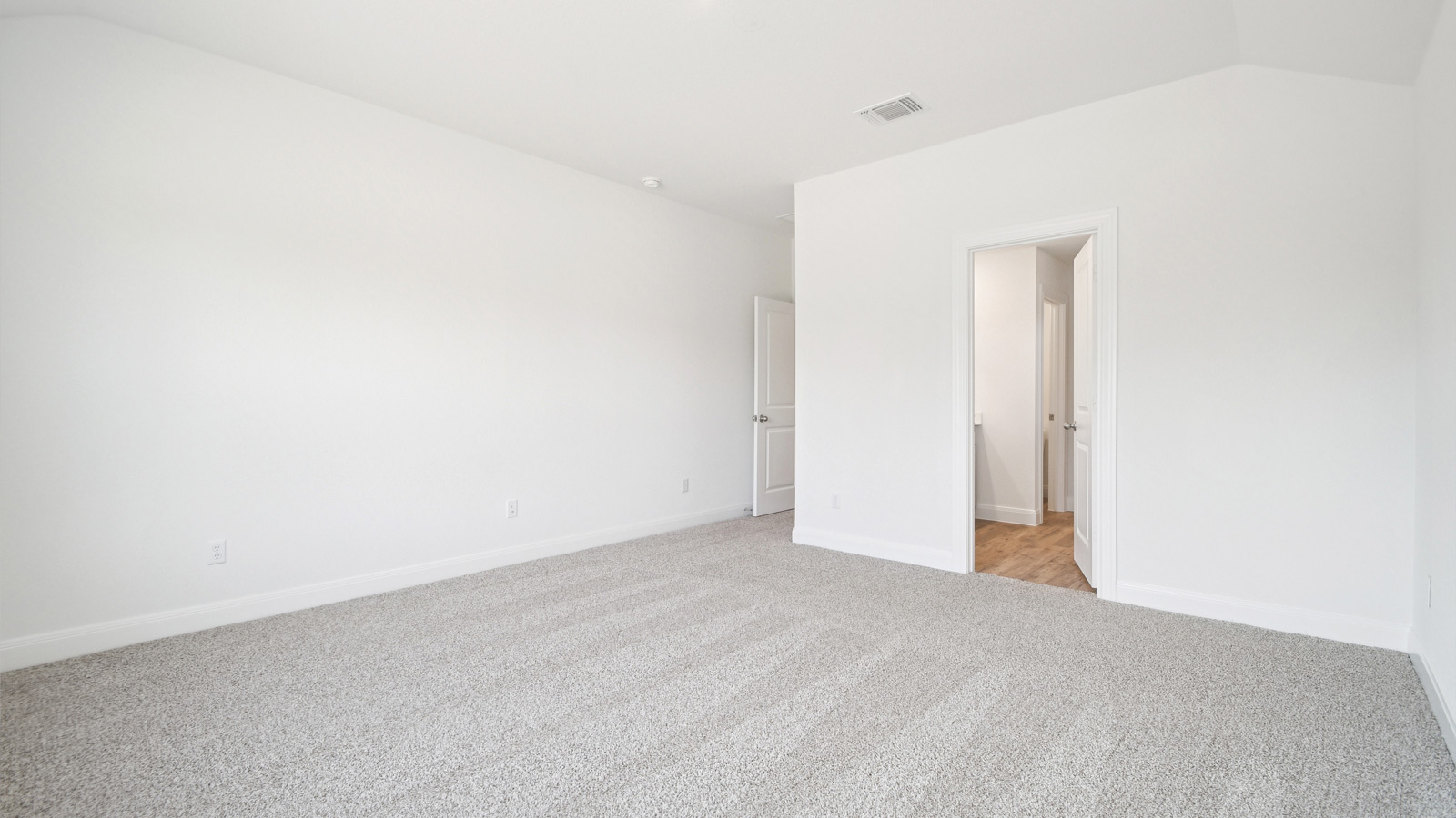 Primary bathroom with carpeted flooring.