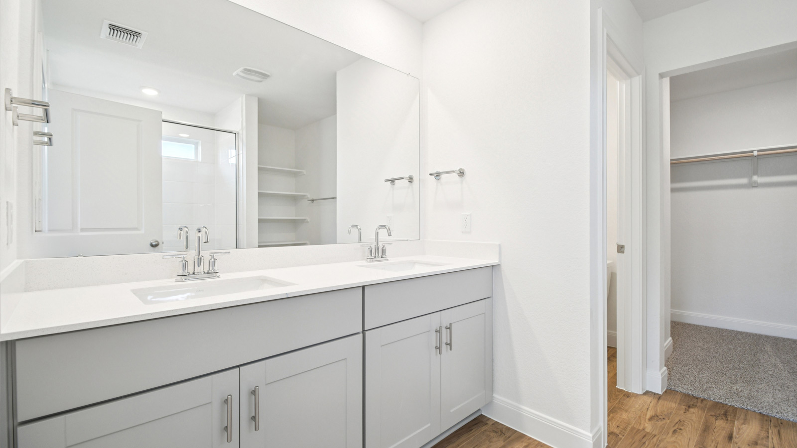 Luxurious primary bathroom with double vanity sink.