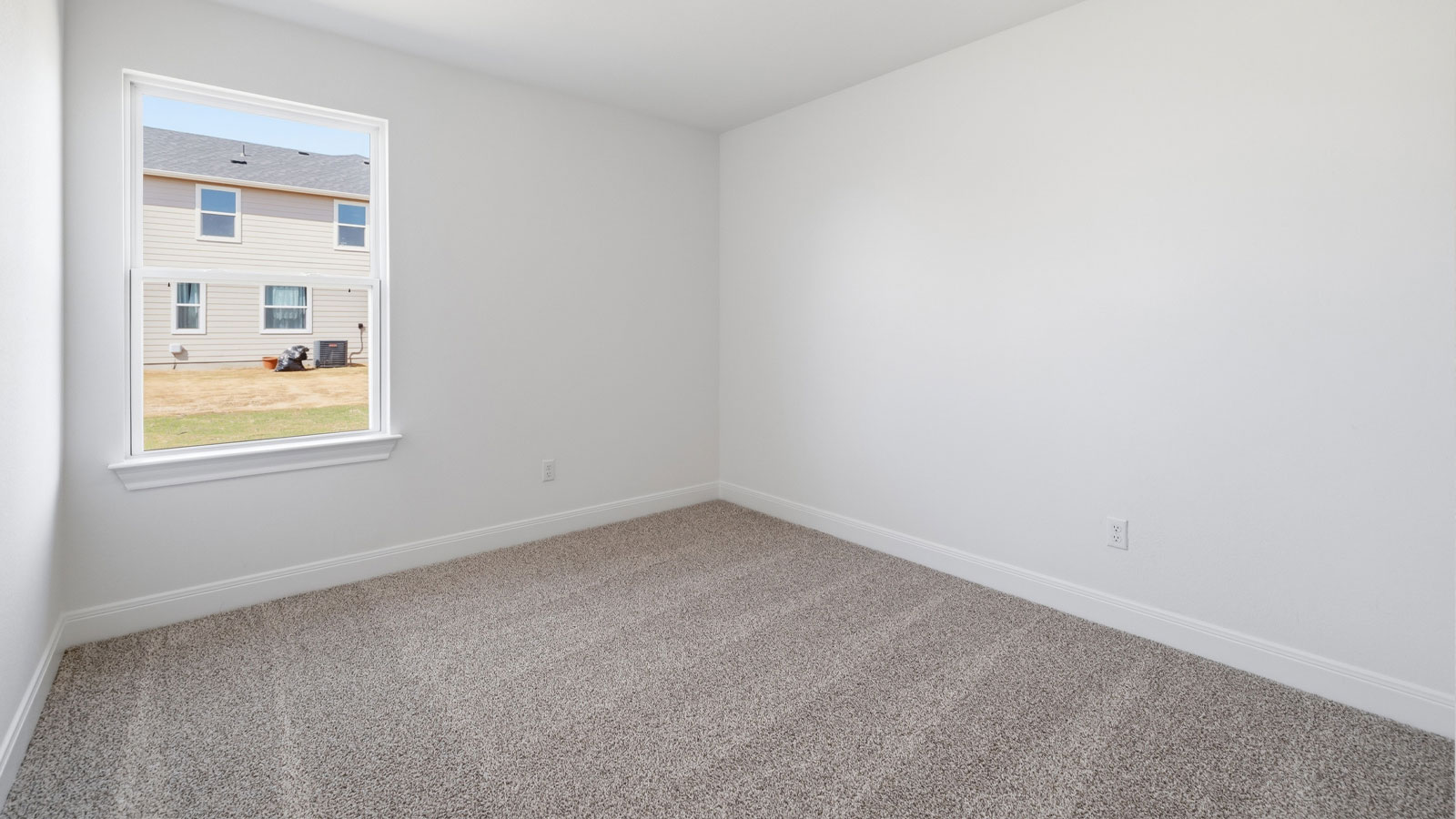 Bedroom 2 with carpeted flooring.