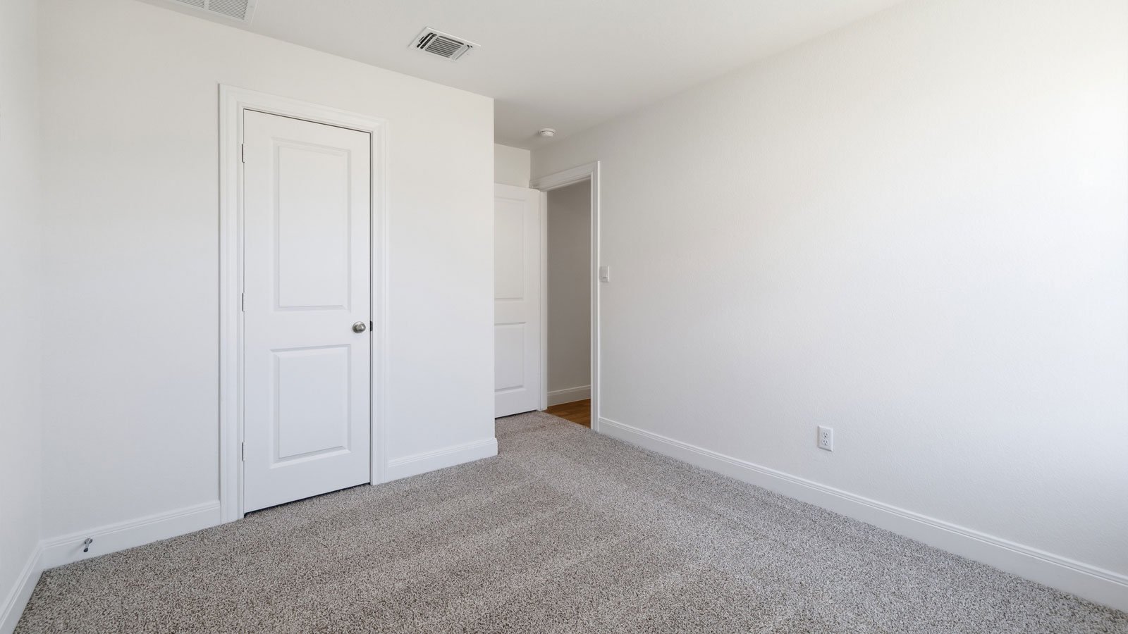 Bedroom 2 with carpeted flooring.