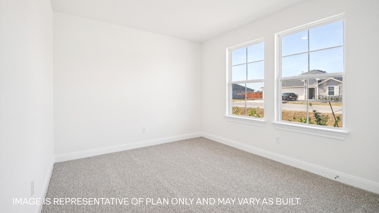 Bedroom 2 with carpeted flooring and large windows.