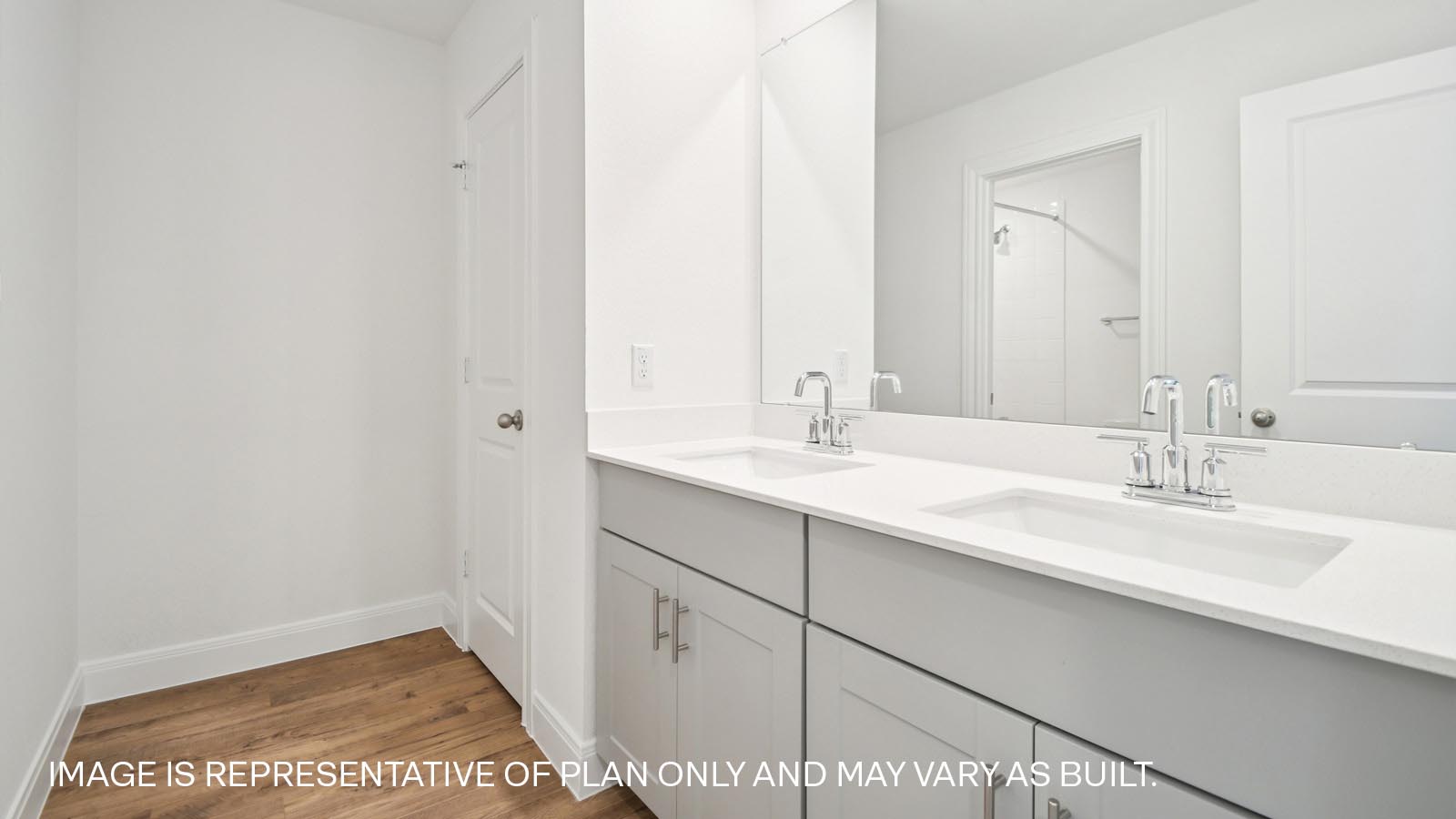 Secondary bathroom with double vanity sink and mirror.