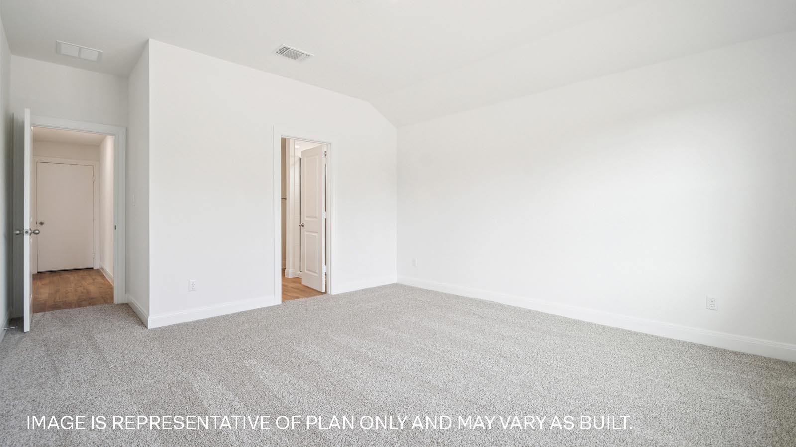 Primary bedroom with carpeted flooring and large window.