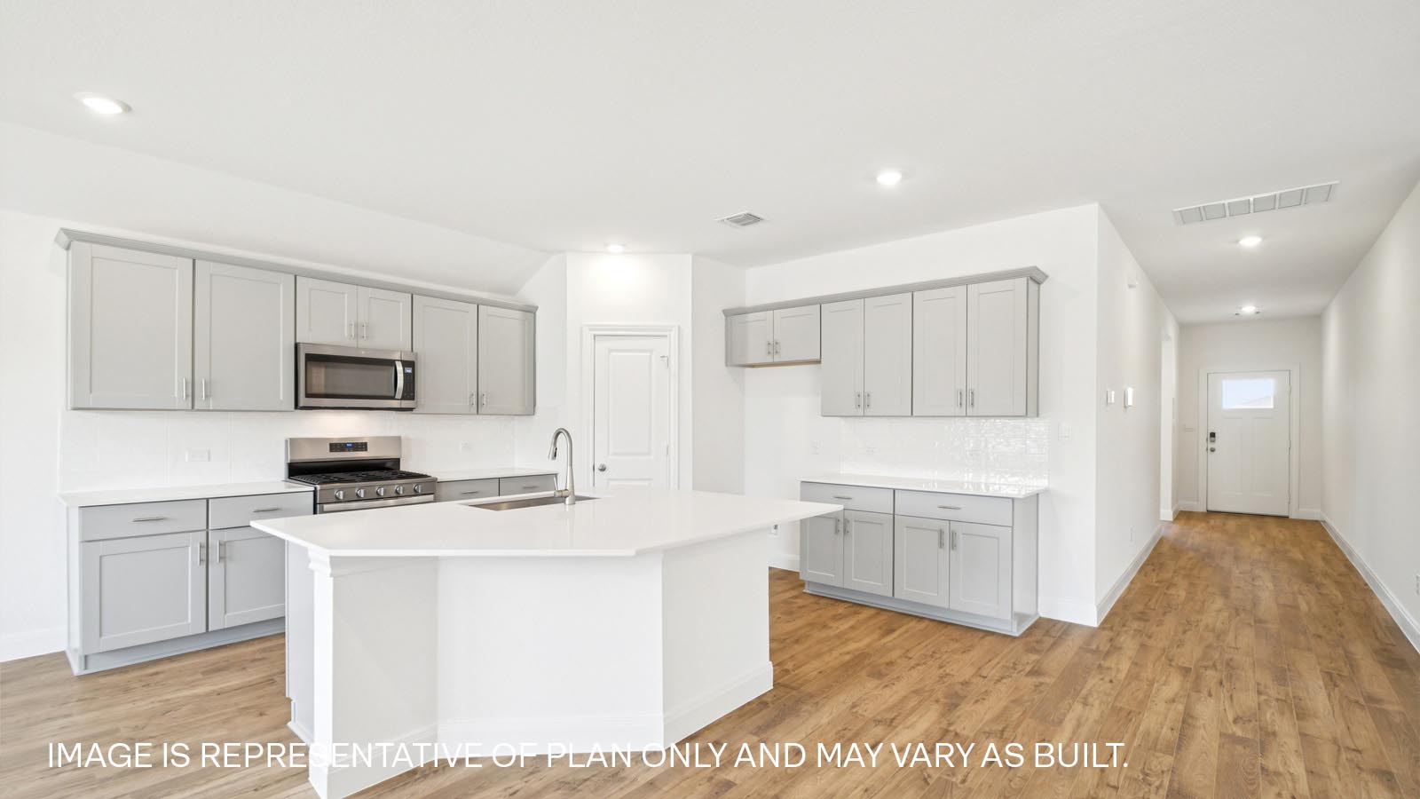 Beautiful kitchen with quartz countertops and decorative style backsplash.
