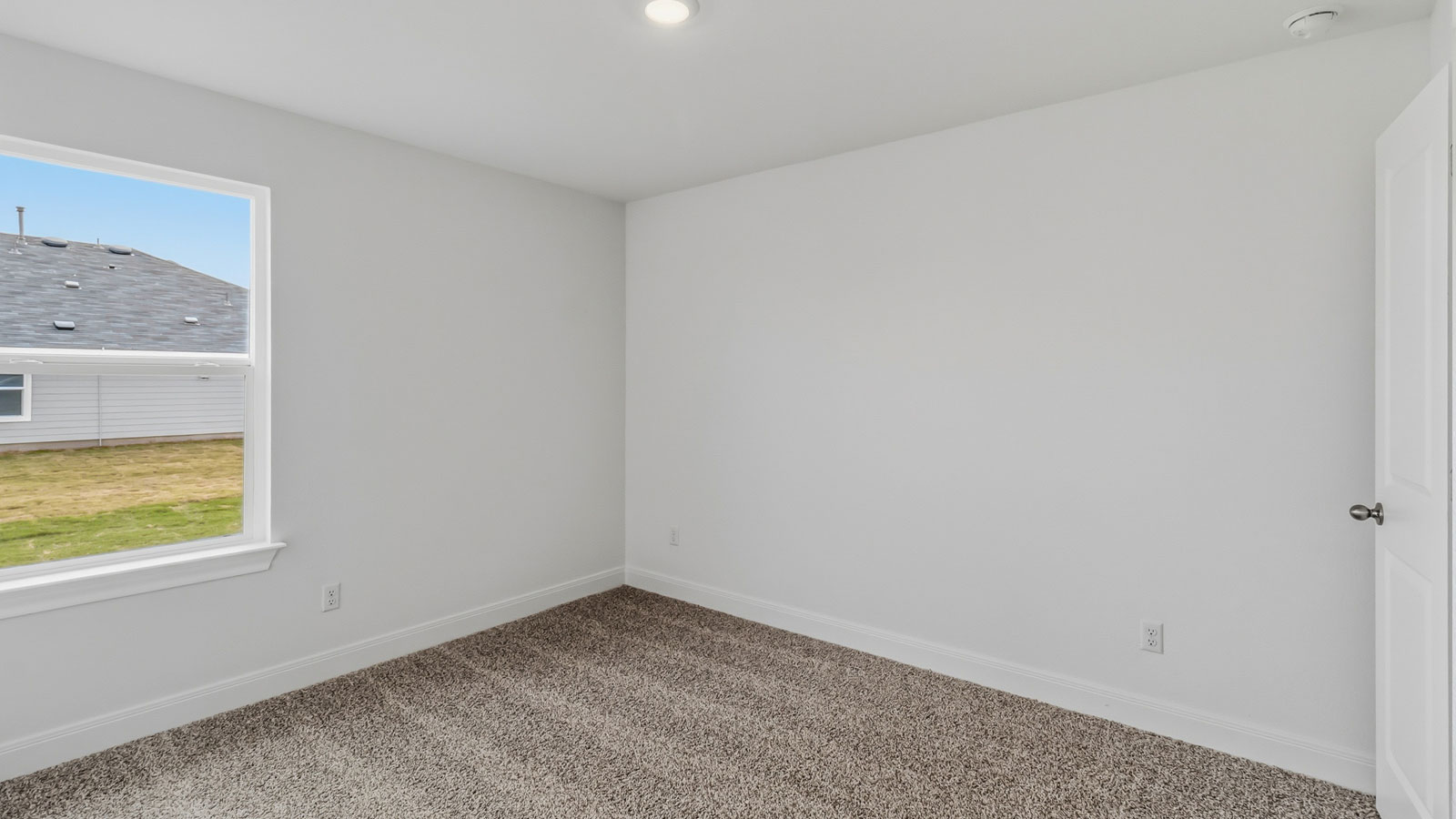 Bedroom 3 with carpeted flooring located at the front of the home.