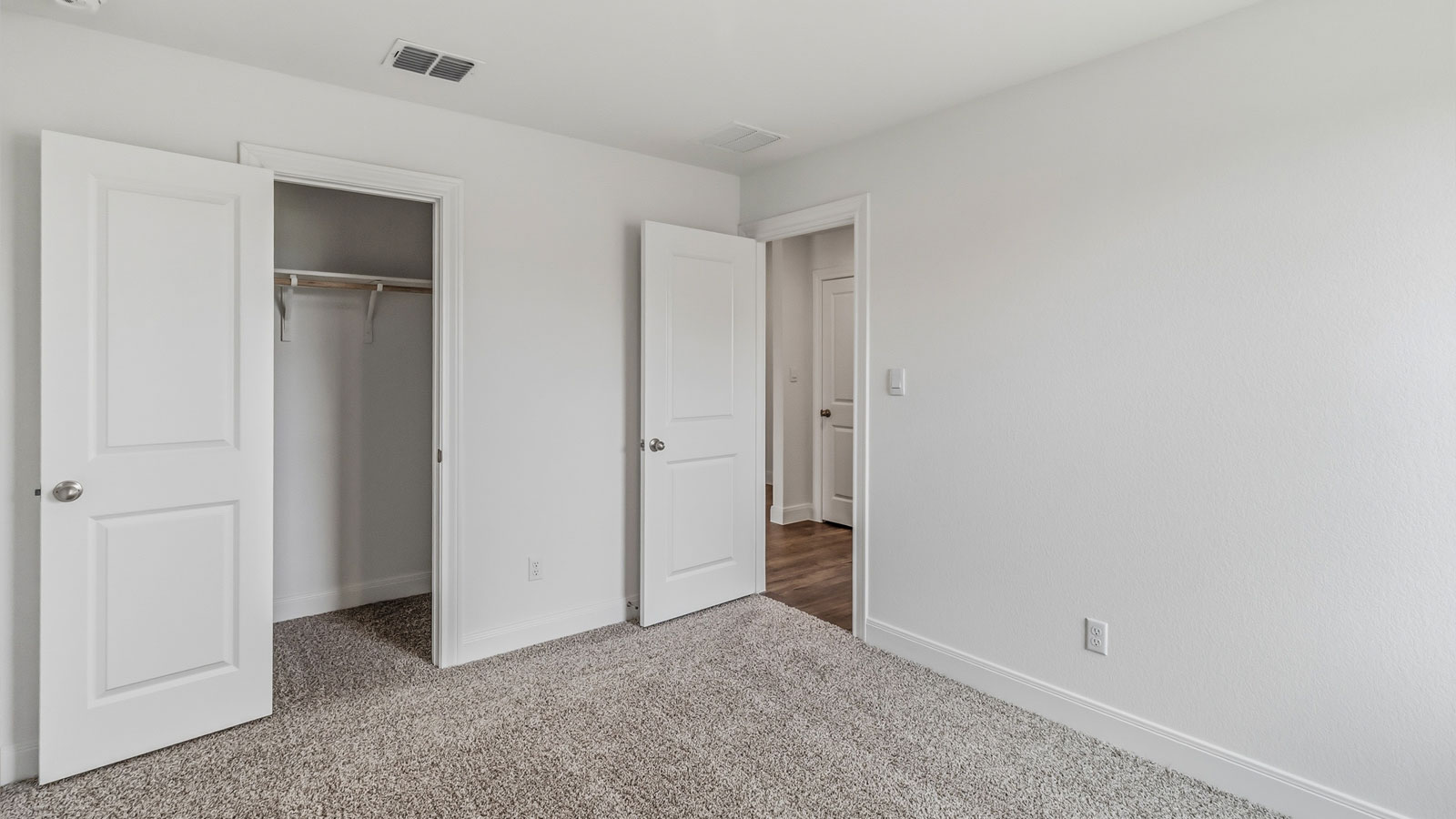 Bedroom 3 with carpeted flooring located at the front of the home.