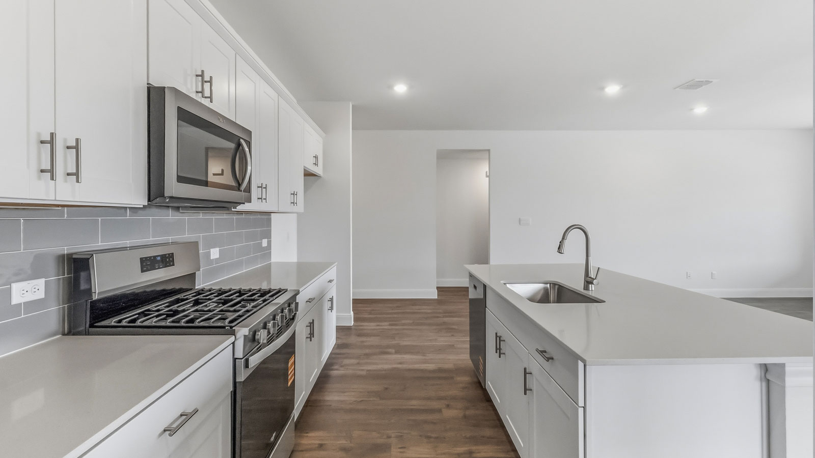 Stainless steel range, microwave, and dishwasher in kitchen.