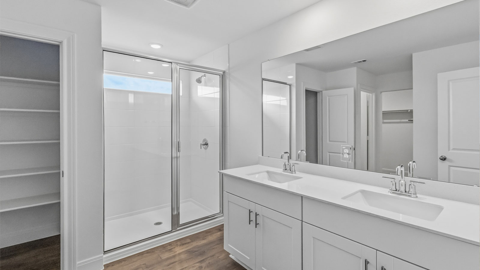 Primary bathroom with walk-in shower and quartz vanity.