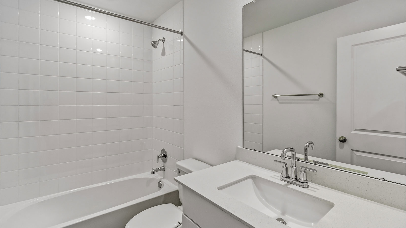 Secondary bathroom with tub and raised shower head.