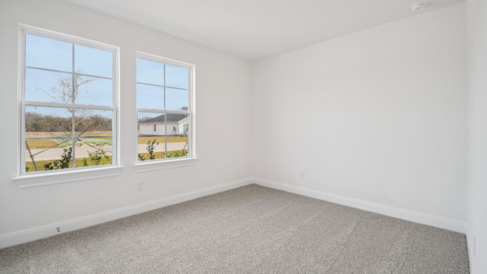 Bedroom 2 with carpeted flooring.