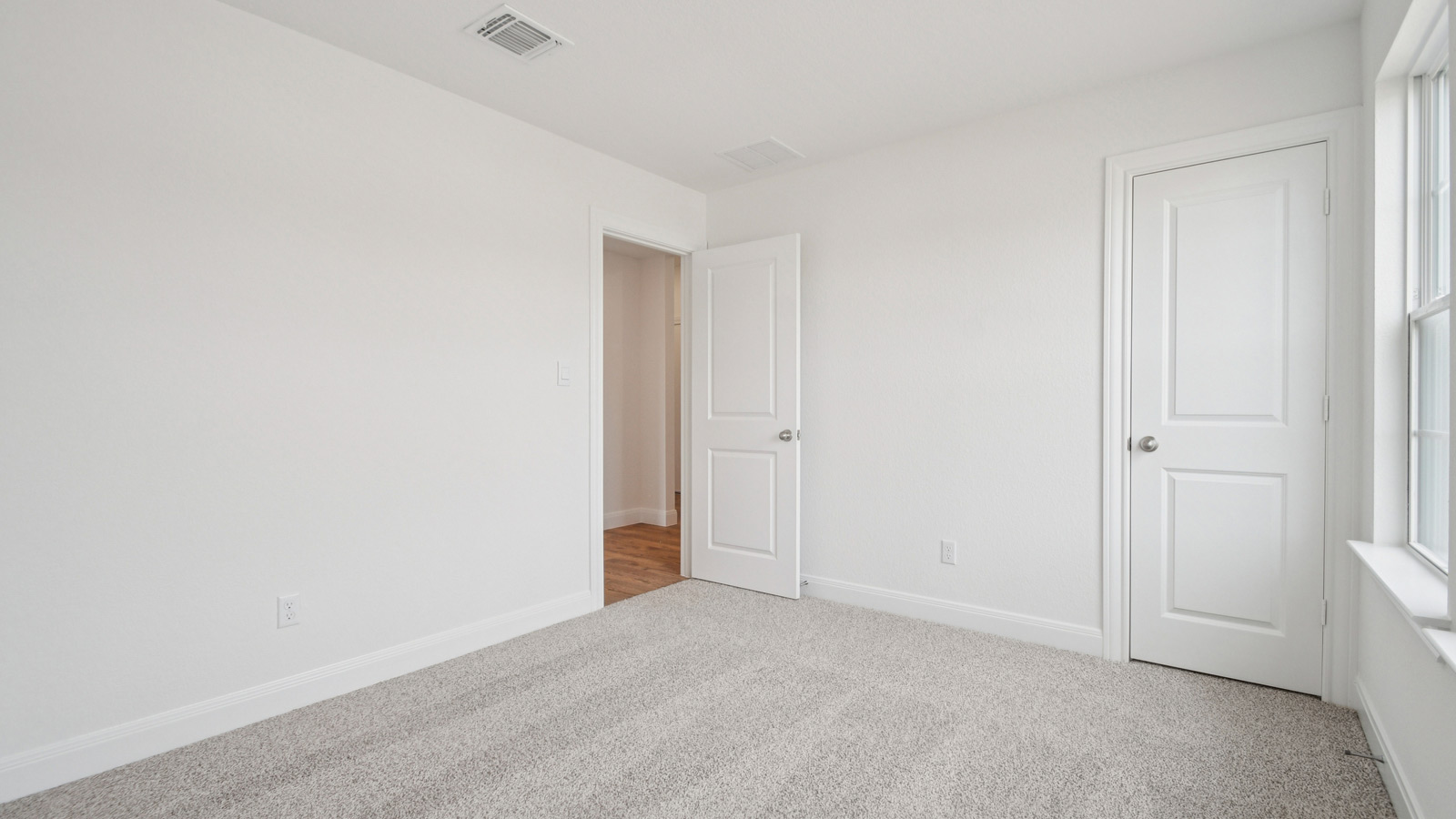Bedroom 2 with carpeted flooring.