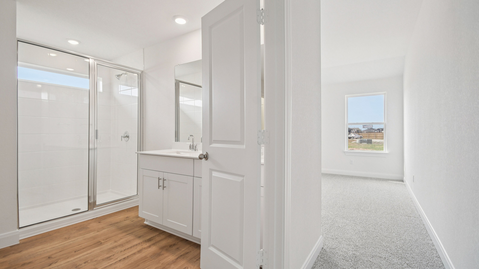 Main bathroom with double doors and walk-in shower.